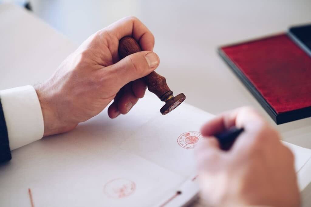 notary public signing and stamping a document